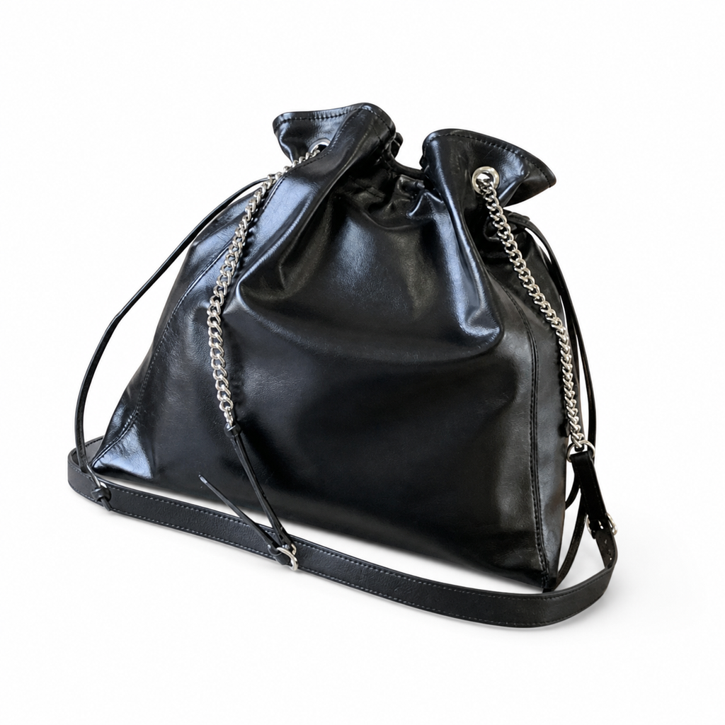 Saint Laurent Drawstring Bucket Bag — Noir Calfskin, Quatrefoil Chain Handle, Leather Drawstring & Tassel